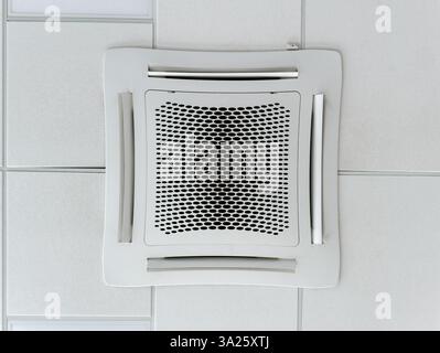 Close-up view of a large room cassette type ceiling air conditioner installed on a suspended ceiling. HVAC system Stock Photo