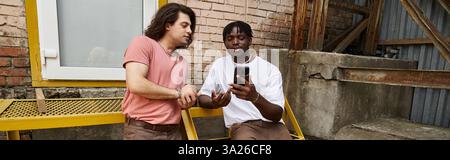 A loving gay couple enjoys their time together, sharing smiles and laughter over coffee. Stock Photo