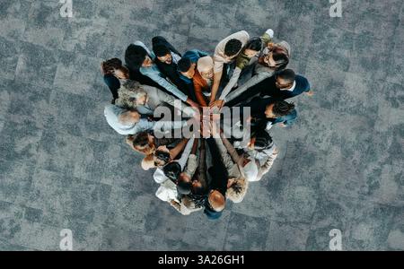 A diverse business group standing in a heart formation, symbolizing unity, teamwork, and collaboration. Stock Photo