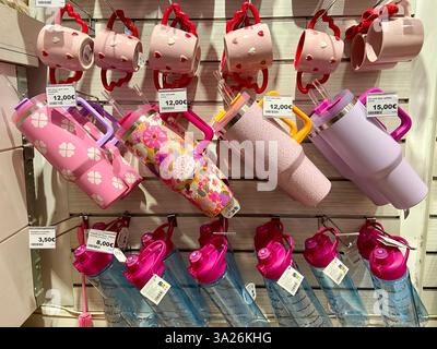 Barcelona, Spain - February 21 2025: Colorful Insulated Tumblers and Ceramic Mugs with Heart and Floral Designs on Store Display. High quality photo Stock Photo