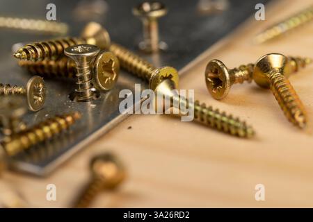 metal corner with a lot of holes for connecting wooden parts with screws, metal building products for connecting wooden structures closeup Stock Photo