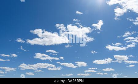 White clouds and sunlight in a blue sky Stock Photo