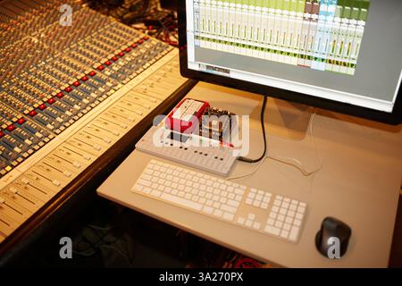 Audio mixing console and computer setup in a professional recording studio. Stock Photo