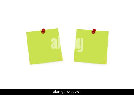 Two blank green paper notes held by red push pins on a white background Stock Photo
