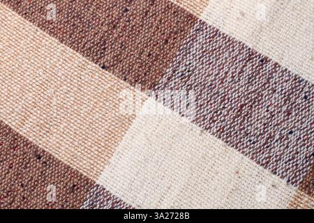 Brown and white checkered fabric texture in a close up view Stock Photo