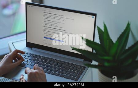 Tallinn, Estonia - 2025.03.08: Woman interacting with ChatGPT AI on a computer. Stock Photo