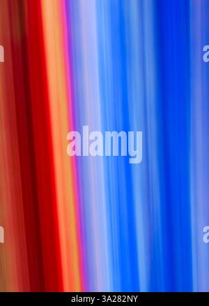 Bright streaks of red, orange, and blue blend together, creating a dynamic flow of colors that evokes energy and passion. The fluidity suggests a tran Stock Photo