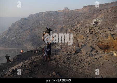 Coal mines of Jharkhand, India A coal scavenger burns coal piles in an ...
