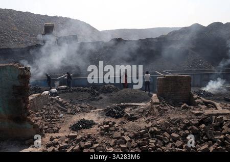 Coal mines of Jharkhand, India Coal scavengers burn coal piles in an ...