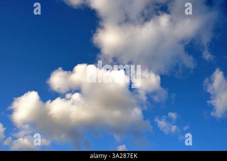Small soft white clouds against a blue sky Stock Photo