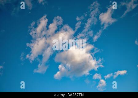 Small soft white clouds against a blue sky Stock Photo