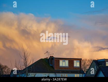 Dramatic winter storm clouds forming over rooftops in a residential area Shepperton Surrey England UK Stock Photo