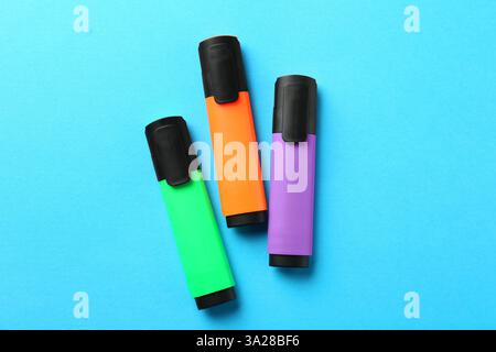 Bright highlighters on light blue background, flat lay Stock Photo
