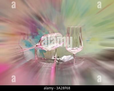 Light art, various glasses on silver foil, behind them various splashes of colour, zoom effect, studio shot Stock Photo