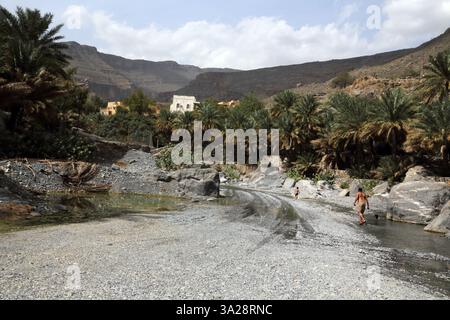 Father and Son in Wadi Ghul Hajar Mountains Al Hamra Oman Stock Photo