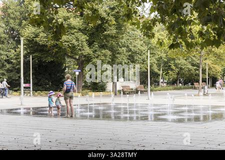 Fountain on the main street with mother and 2 children, Jorge-Gomondai-Platz, Dresden, Saxony, Germany, Europe Stock Photo