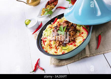 Tajin with couscous, vegetables and meat on a white background Stock Photo