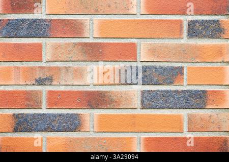 Colored red orange brick wall background Stock Photo