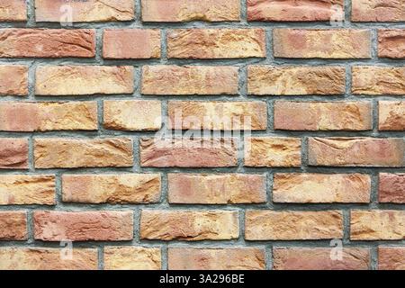 Colored red orange brick wall background Stock Photo