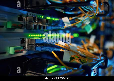 Blue and yellow wires. Close up view of hardware in the server room. Stock Photo