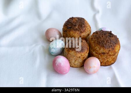 three whole wheat Easter cakes and pastel color Easter eggs Stock Photo