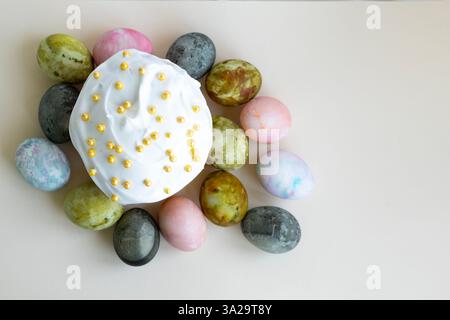 Easter cake with white icing and Easter eggs, top view Stock Photo