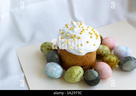 Easter cake with white icing and Easter eggs Stock Photo