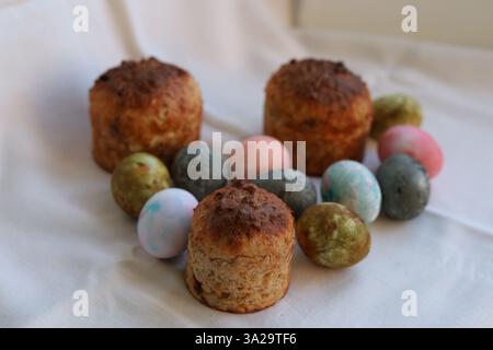 Easter cakes and colorful Easter eggs on a white tablecloth Stock Photo