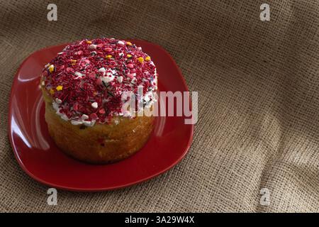 Easter cake with icing on a red plate Stock Photo