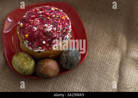 Easter cake and Easter eggs on a red plate Stock Photo