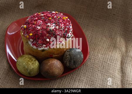 Easter cake with Easter eggs on a red plate Stock Photo