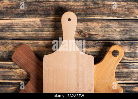 Gastronomic concept, several cutting boards on a dark rustic wooden table, top view. Stock Photo
