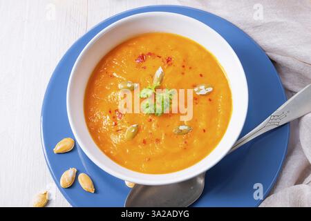 Healthy pumpkin soup with ginger, carrots and coconut milk Stock Photo