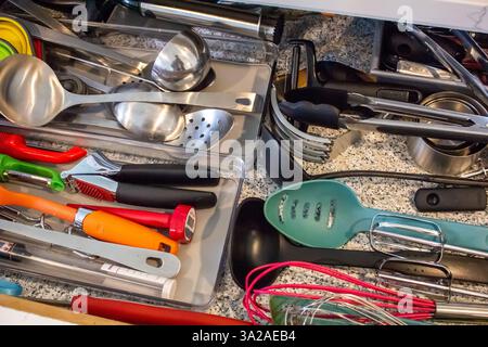 A view of a kitchen drawer full of assorted cooking utensils. Stock Photo