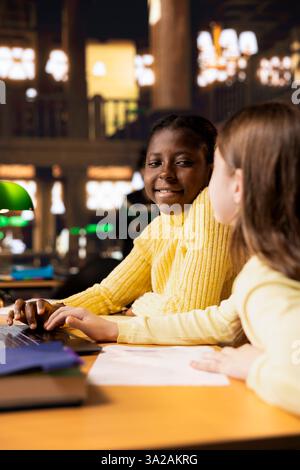 Schoolgirls working on school project in class Stock Photo - Alamy