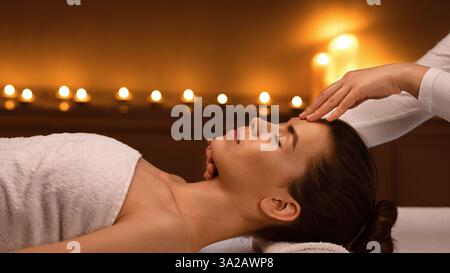 Spa therapist making relaxing acupressure massage for lady Stock Photo