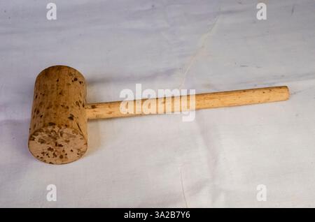Closeup of a Meat Mallet On White Fabric Stock Photo