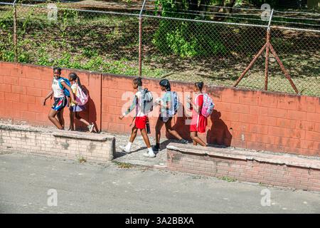 St John's Antigua and Barbuda,Newgate Street,students walking home from school,Black African girls adolescents friends,backpacks school bags,after sch Stock Photo