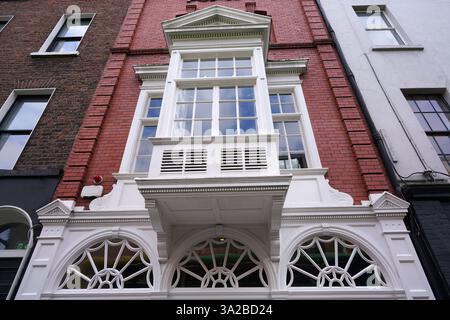 Vintage with projecting bay window above fanlight windows Stock Photo