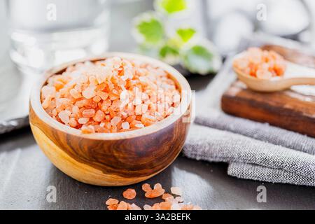 pink Himalayan salt in a ceramic cup on a chalkboard Stock Photo