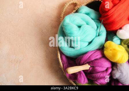 tray with different wool for felting and needles on color background, closeup Stock Photo