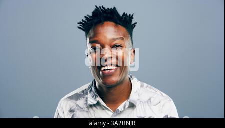 Fashion, studio and portrait of man, laughing and stylish outfit for model, mockup and trendy for guy. Blue background, student and black person with Stock Photo