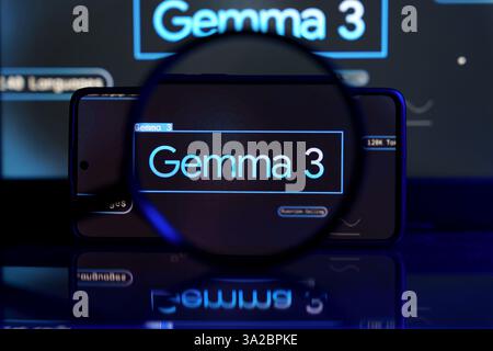 Smartphone screen displaying Google Gemma 3 AI model, with a larger screen in the background. The image emphasizes artificial intelligence and digital Stock Photo