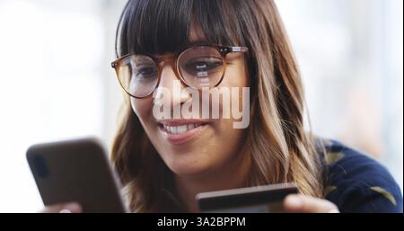 Office, woman and information with smartphone for credit card, payment and banking app for ecommerce. Smile, female person and reading with mobile Stock Photo