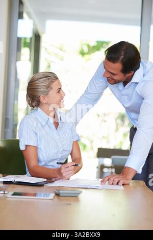 Woman, man and documents with assistant, discussion and progress for budget, happy and financial review. Business people, entrepreneur and accountant Stock Photo