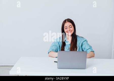 Business woman working at desk on laptop online learning in office Stock Photo