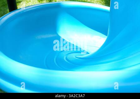 clean blue slide in colorful children's playground during the day Stock Photo