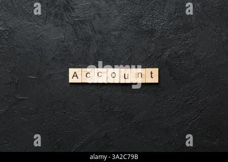 Account word written on wood block. Account text on cement table for your desing, concept. Stock Photo