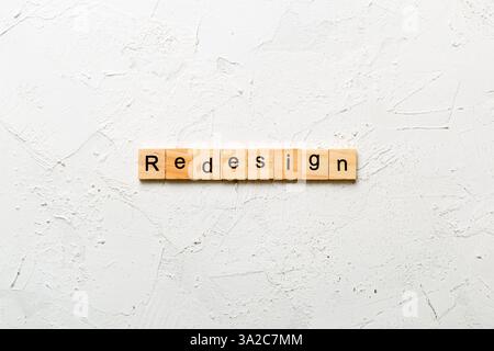 REDESIGN word made with wooden blocks concept. Stock Photo