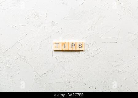 tips word written on wood block. tips text on table, concept. Stock Photo